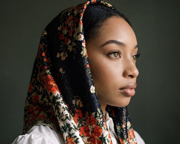 Profile portrait in a floral headscarf