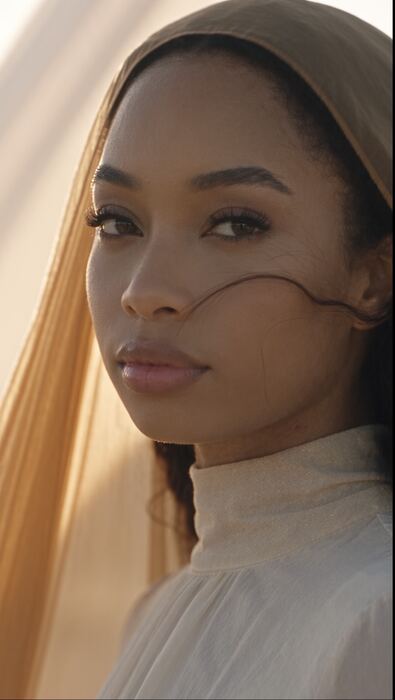 Orie in warm golden light with a sheer veil