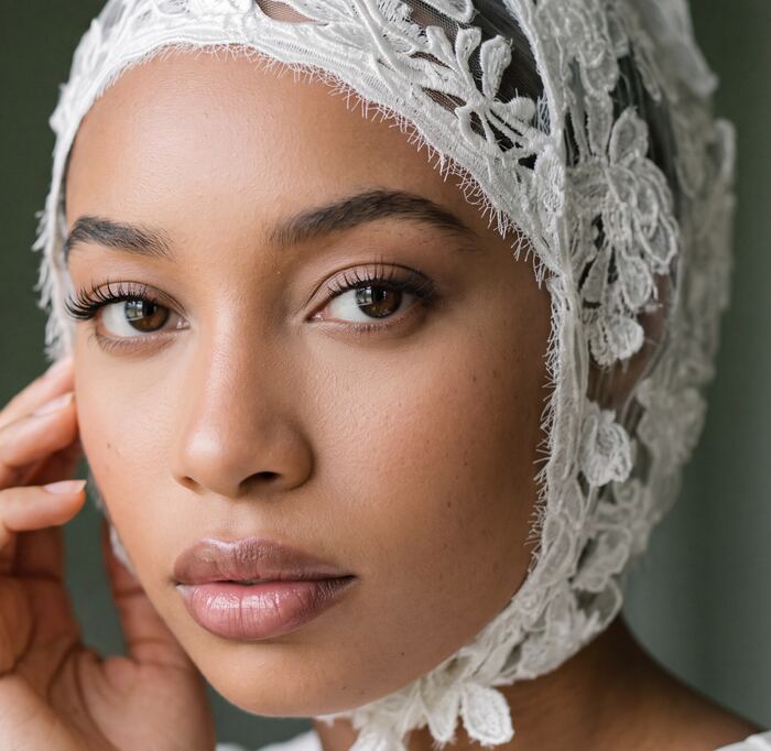 Close portrait in a white lace head covering